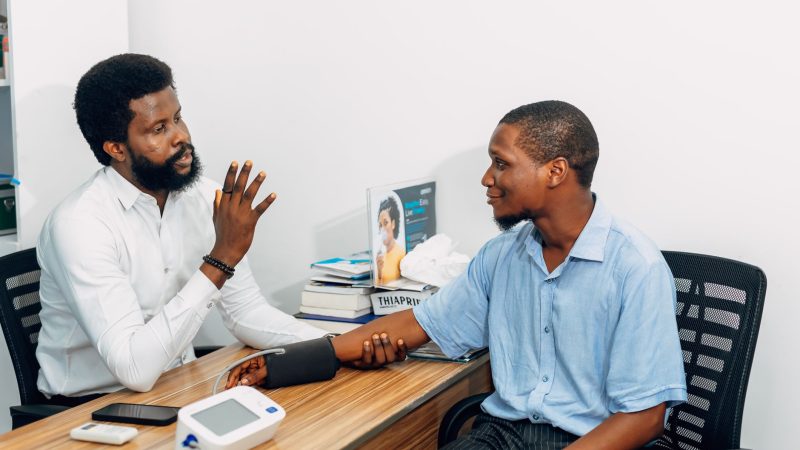 A medical professional consults with a patient during a blood pressure checkup in Lagos, Nigeria. — Experience Coordinated Ca