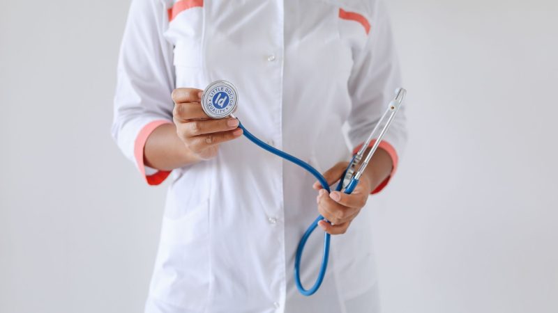 Close-up of a female doctor holding a blue stethoscope, emphasizing healthcare and professionalism. — Stay Committed to Your 