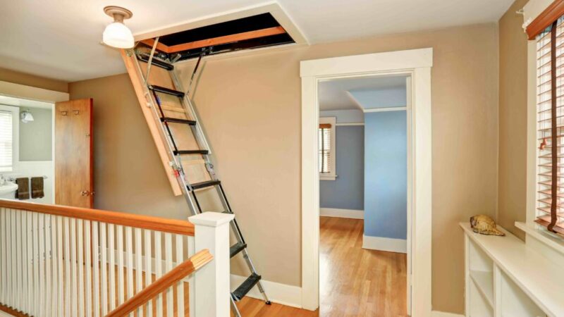 A retractable loft ladder installed in a home, leading to an attic opening.